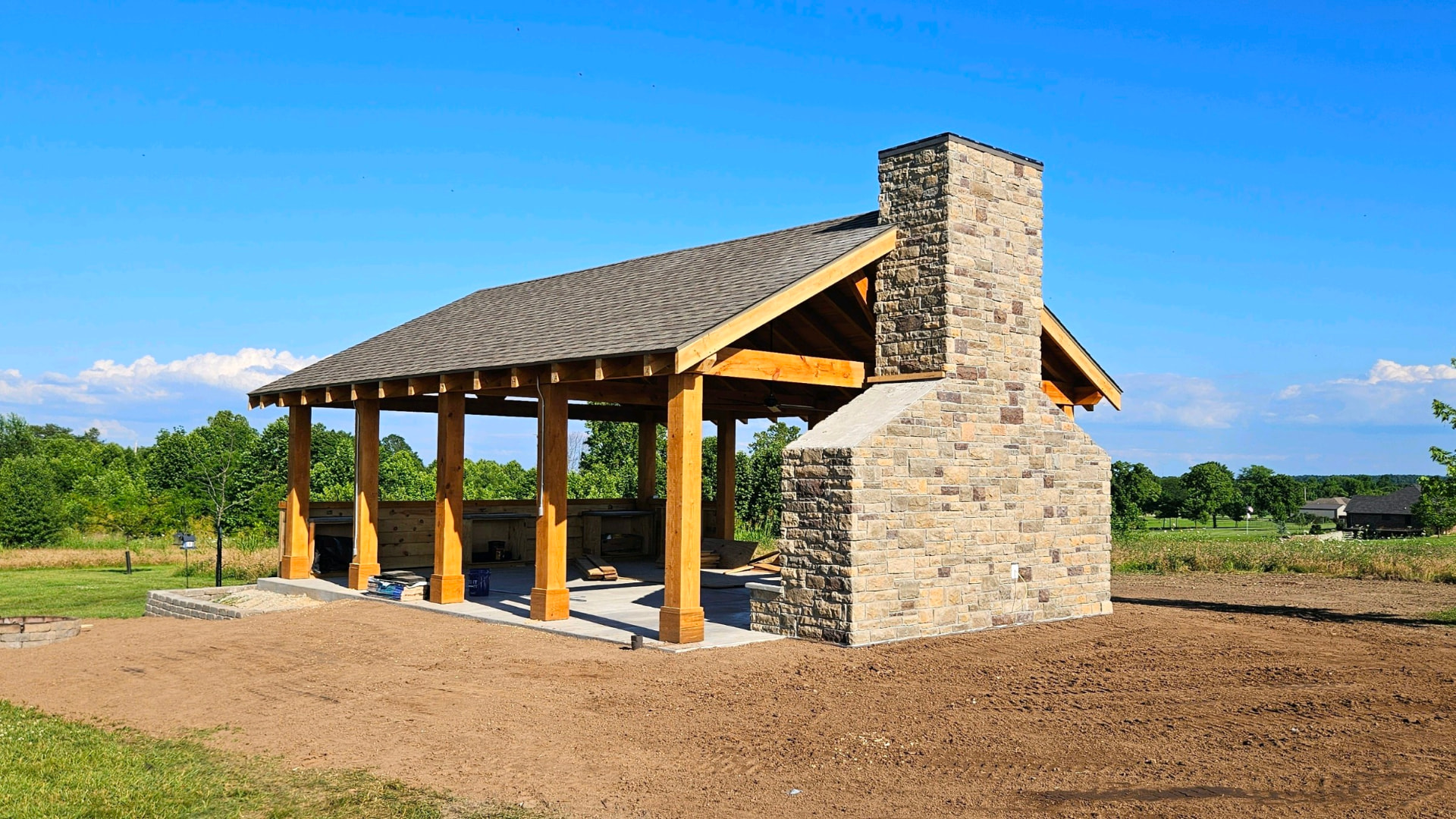 Timber pavilion with stone fireplace and chimney