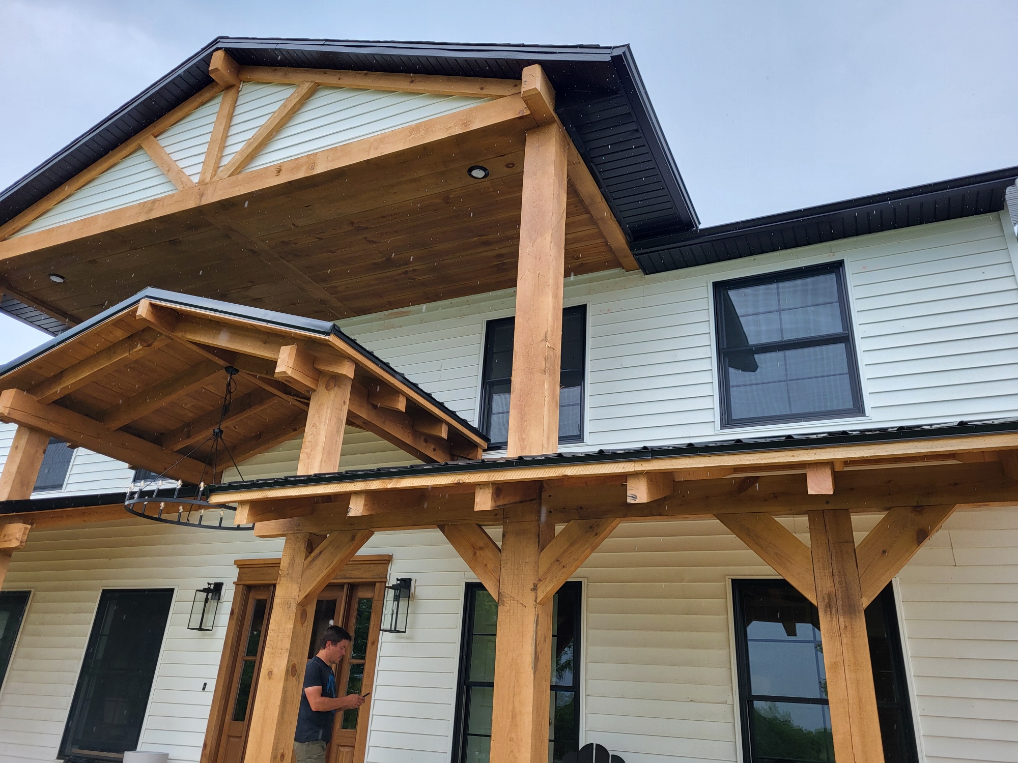 Timber frame front porch with a gabled roof