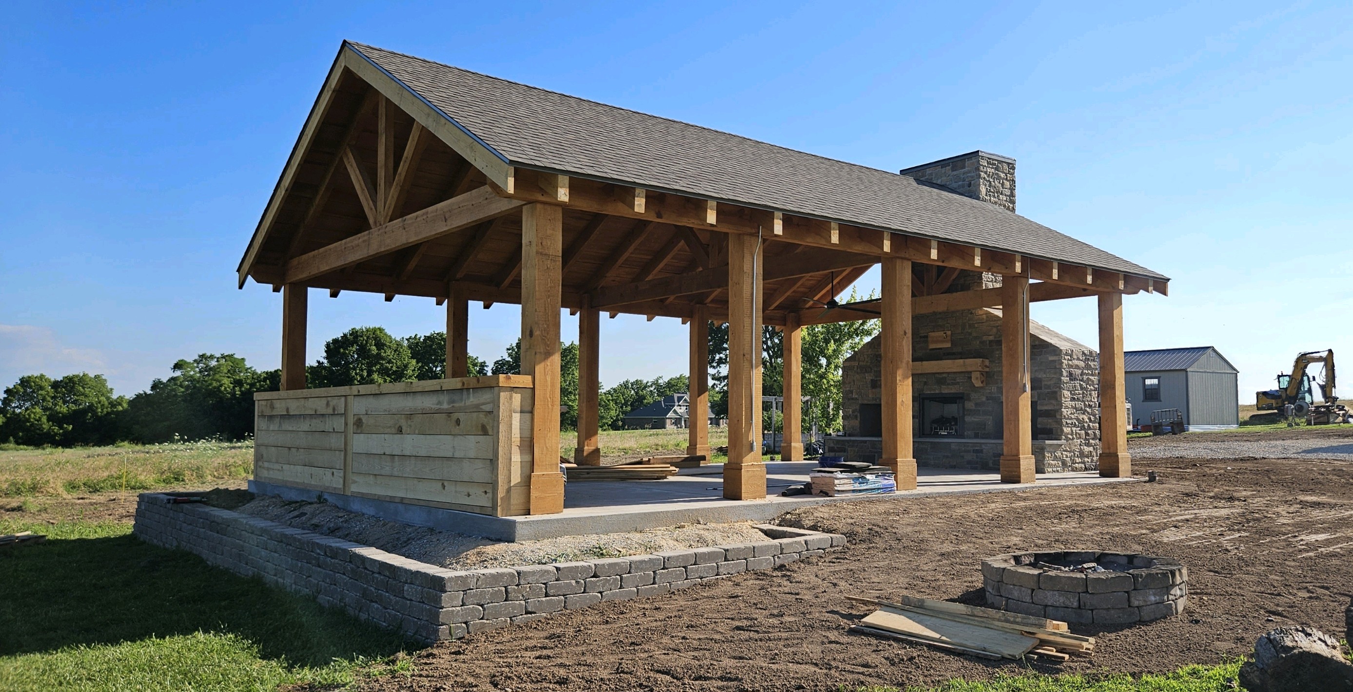 Timber frame pavilion with a stone fireplace