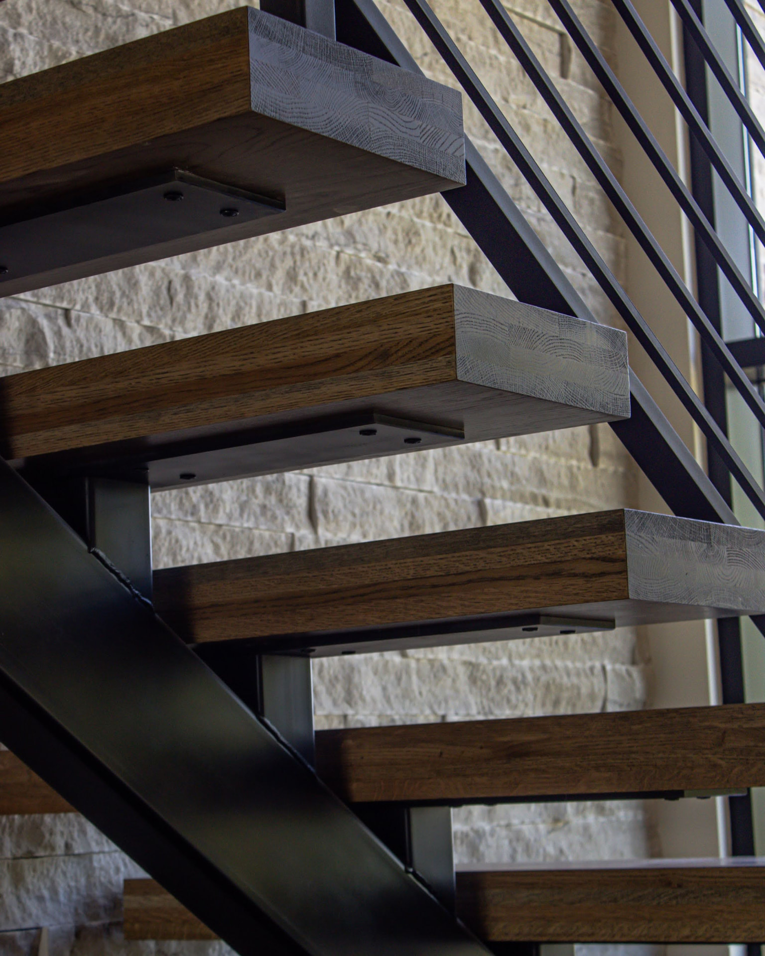 Floating white oak stair treads on a steel stringer