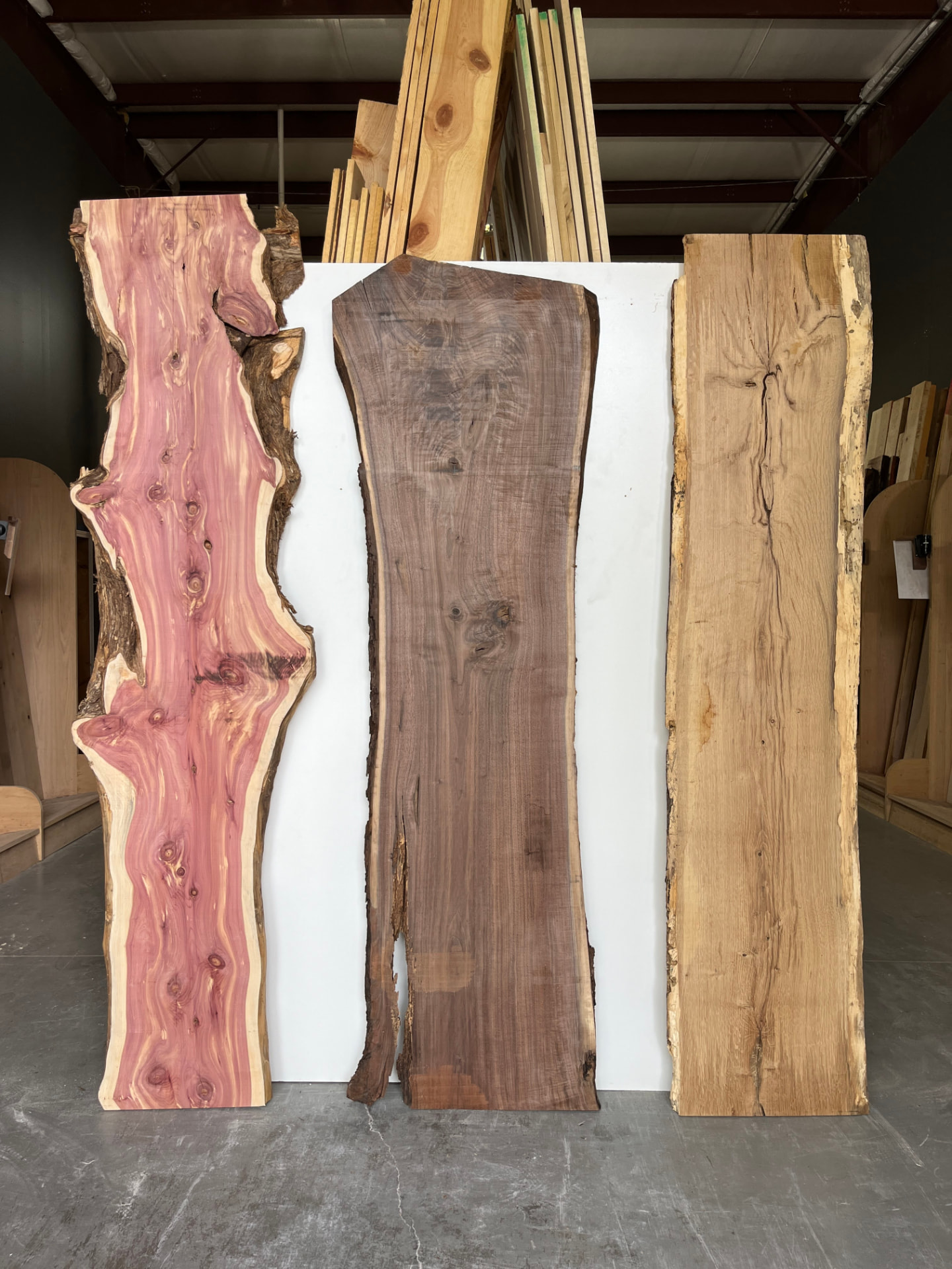 Three live edge slabs standing in the OSL Hardwood Store showroom