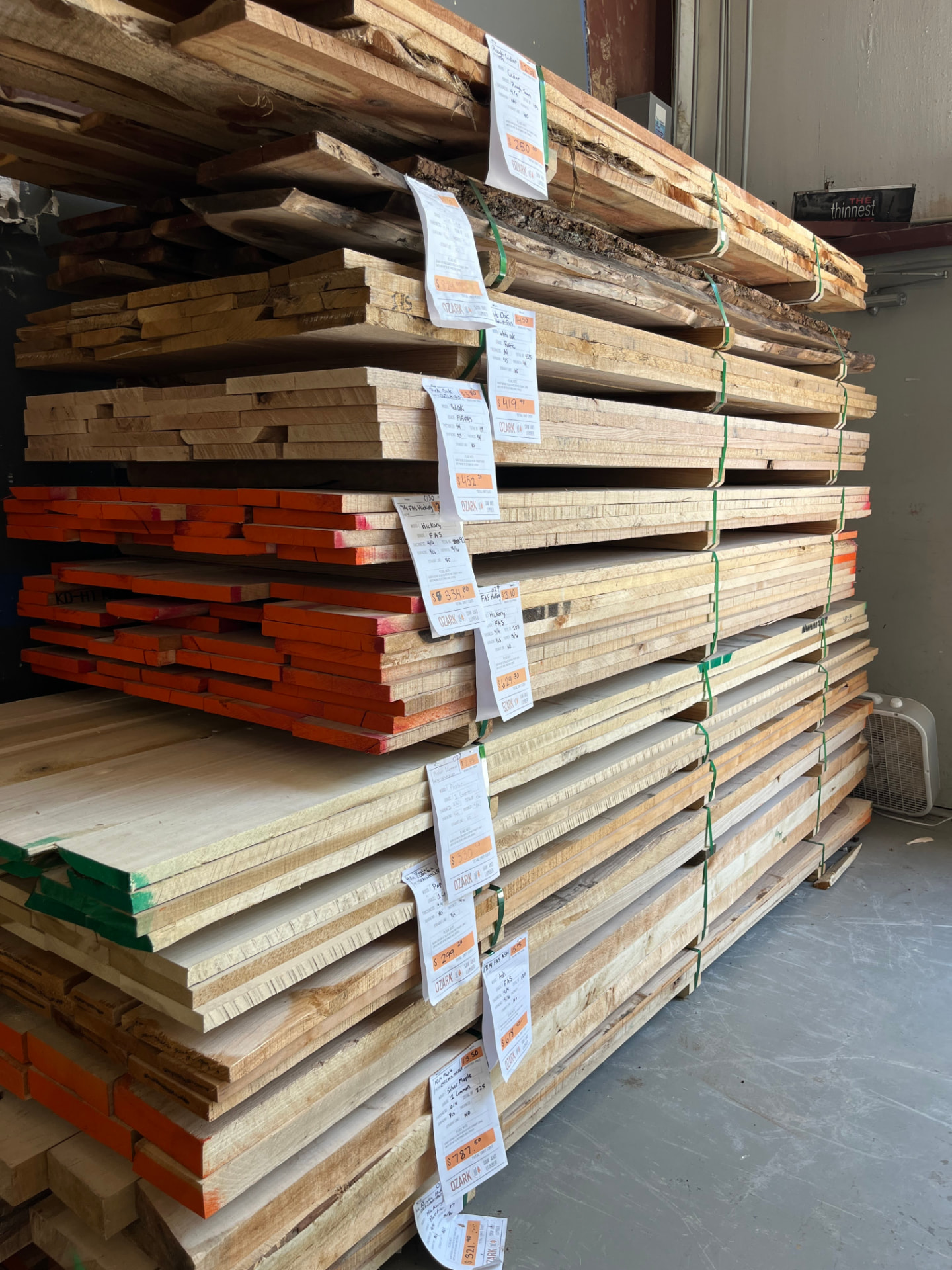Tagged and priced hardwood lumber packs in the store